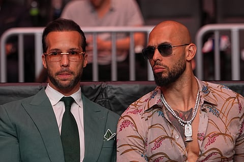 FILE - Andrew Tate, right, and his brother Tristan arrive at an event, April 11, 2026, in Miami.
