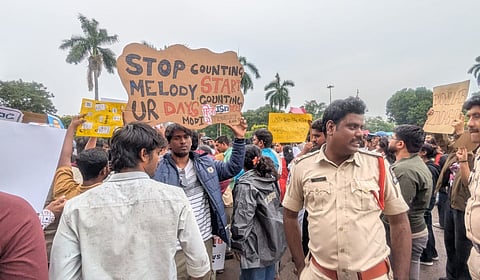 A poster addressing Prime Minister Modi with the caption, "Stop counting melody, start counting your days.'