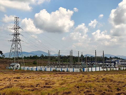 Image of a KSEB substation with transmission towers and electric lines
