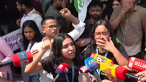 Image featuring students protesting outside the program hall