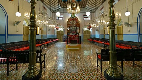 Interior part of a jewish synagogue. Marble floor tiles, lights and chairs can be seen