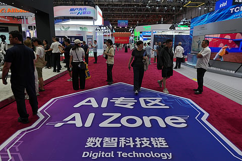 Visitors tour the exhibition booths operated with Artificial Intelligence (AI) at the China International Supply Chain Expo in Beijing.