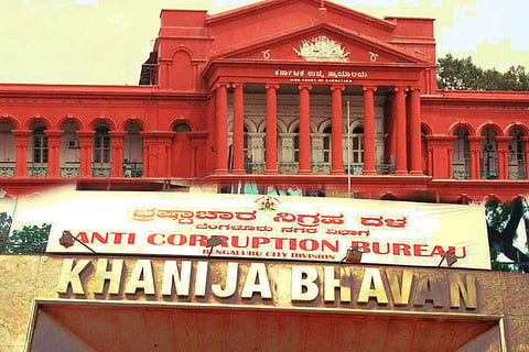 The signboard of the Karnataka ACB superimposed on an image of the High Court.