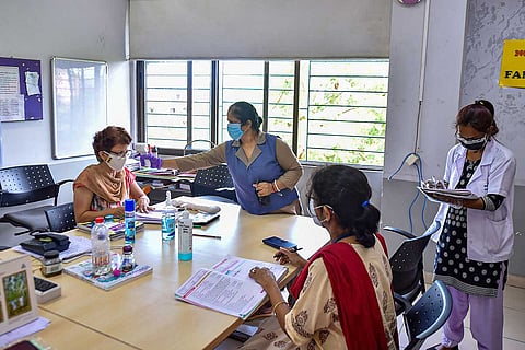 A school in Kolkata where faculty is having their temperature scanned