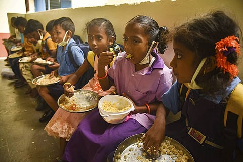 Children eating mid-day meals in a school.