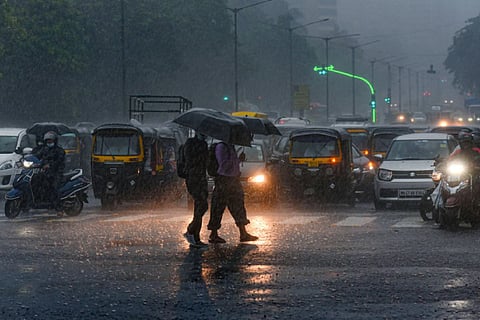 People walking in rain with umbrellas