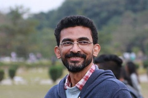 Sekhar Kammula looking away from the camera and smiling