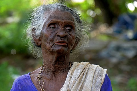 In Kerala, this old woman tries vainly to keep an old pond bed garbage free