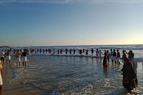 Kerala villagers form human chain to mark 1 year of protests against beach sand mining