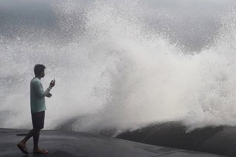 A man standing on the coast of Chellanam in Ernakulam, watching the rough sea during cyclone Tauktae