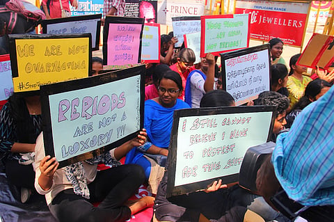 With a giant sanitary pad replica, students and NGOs in Chennai protest 12% GST on napkins