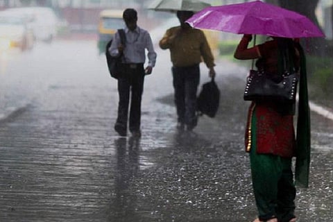 People standing in the rain