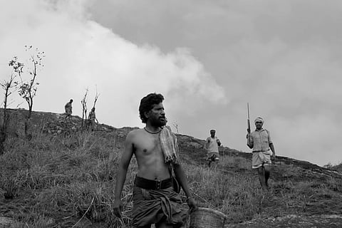 Black and white still from Don Palathara's 1956 Central Travancore that shows men on the hunt