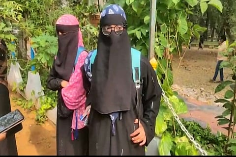 The burqa-wearing students speaking with reporters inside the college