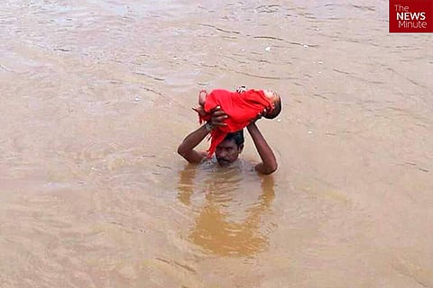 Andhra man wades through shoulder-level water carrying sick kid to hospital