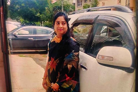 Archana Reddy standing beside a car