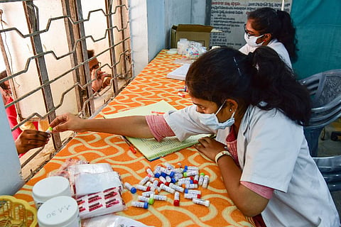 A doctor distributes homeopathy medicine claimed to prevent COVID-19