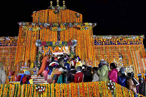 Devotees wait outside the Badrinath Temple for the 'morning darshan', in Chamoli district of Uttarakhand