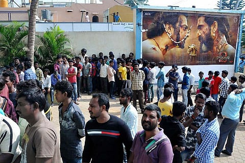 Movie fans wait at a theatre in Chikmagalur to watch the Bahubali 2