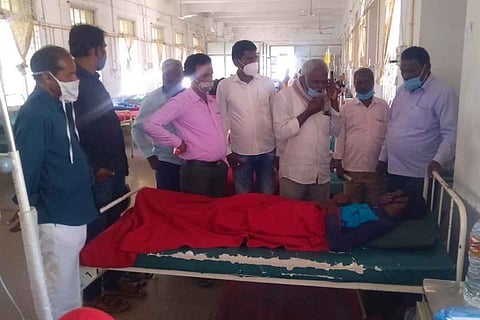 Basava at the hospital surrounded be several people