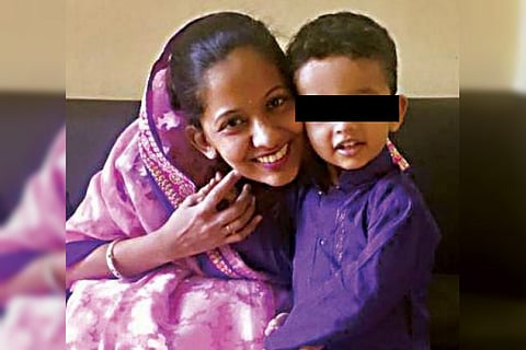 Bengaluru woman who fell off balcony with 2-yr-old son was harassed by husband: Police