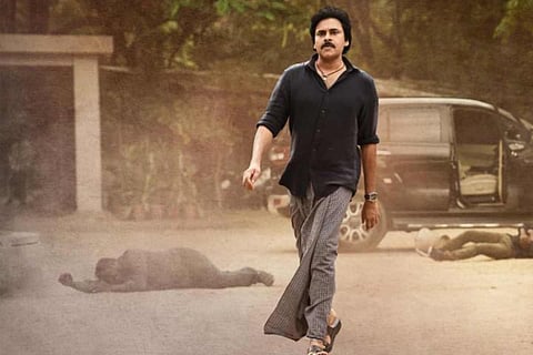 A shot of Pawan Kalyan walking in a lungi and black shirt