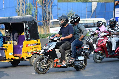Two men riding on a bike