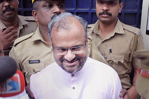 A file photo of Bishop Franco being escorted by the police