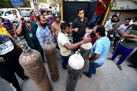People enquire about availability of cylinders of medical oxygen, required for treatment of critical COVID-19 patients in New Delhi.