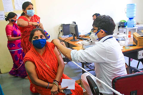 A woman getting the COVID-19 vaccine
