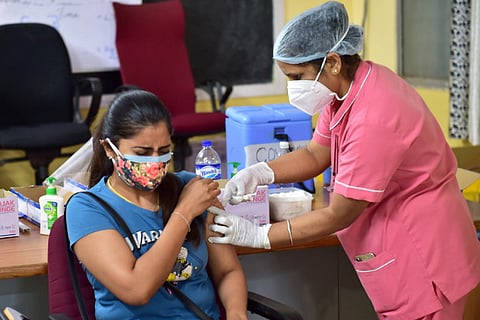 A woman getting a COVID-19 jab
