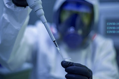 A lab staff storing vaccine in a vial