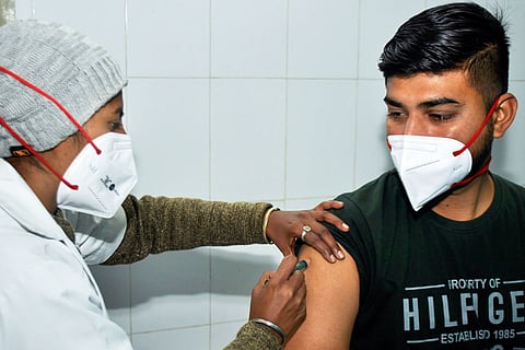 A person receiving a vaccination shot for the coronavirus