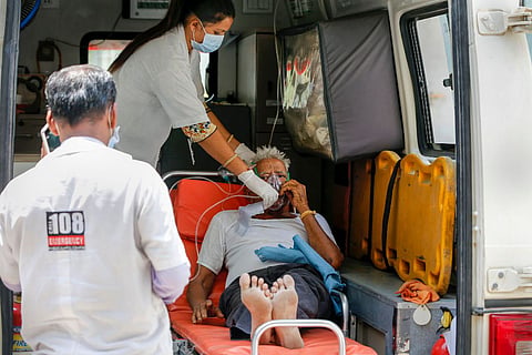A COVID patient given an oxygen supply mask inside an ambulance in Ahmedabad
