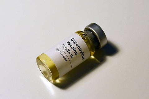 A representative image of a small bottle with a label saying COVID-19 vaccine