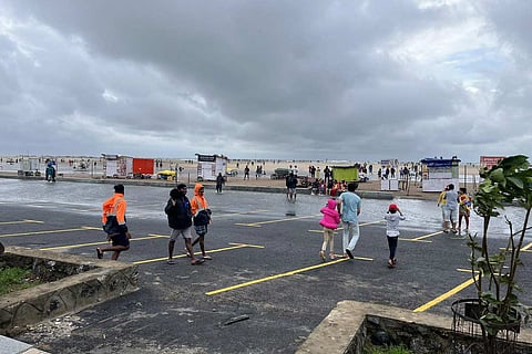 Chennai rains: People seen around Marina beach in Chennai under a cloudy sky