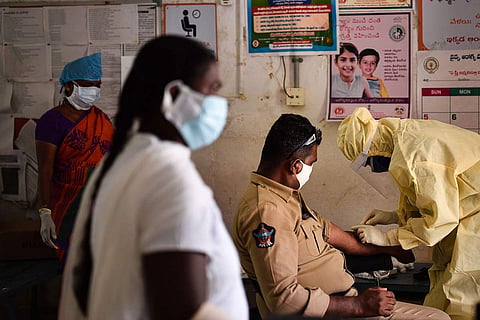 A policemen gets tested for the coronavirus in Vijayawada