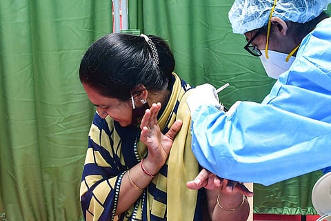 A woman receives a dose of COVID-19 vaccine