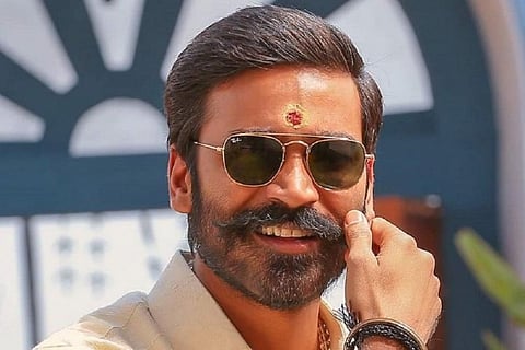 actor Dhanush is seen twirling his moustache