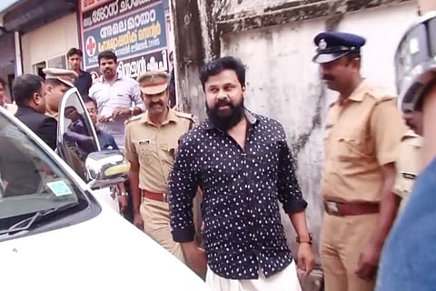 Dileep in black checked shirt with cops