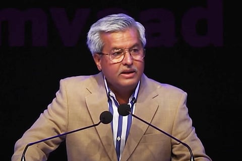 A file image of Dushyant Dave wearing a brown blazer and speaking at an event organised by Manthan foundation