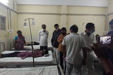 People being treated in a hospital as West Godavari officials inspect them