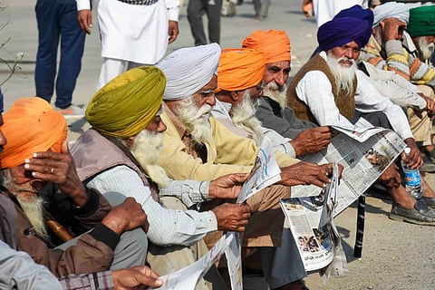 Protesting Farmers in Delhi reading the newspaper at the Singhu Border