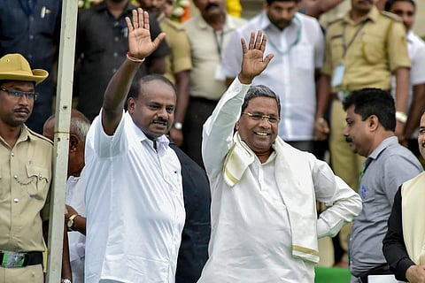 HD Kumaraswamy standing with Siddaramaiah and greeting the crowd