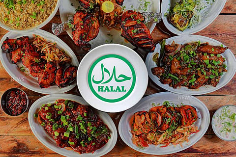 Many food items on a table with Halal written in the middle