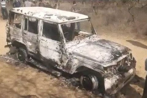 A charred white colored vehicle