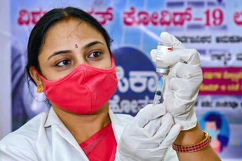 A healthcare worker administering COVID-19 vaccine