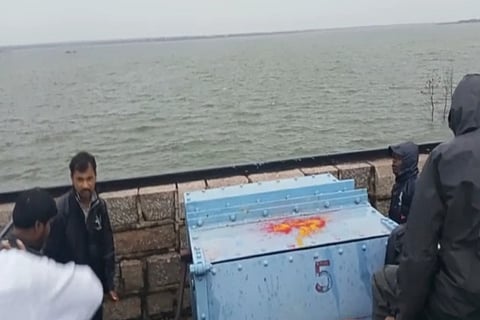 Officials lifting a gate at Himayat Sagar reservoir in Hyderabad