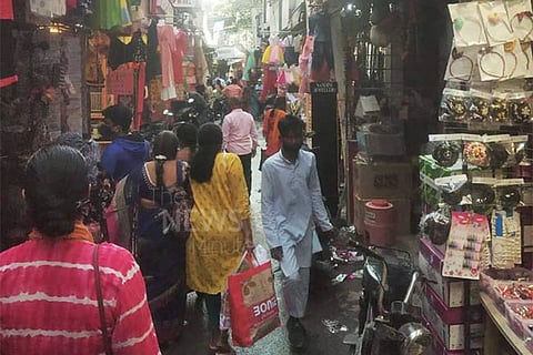 A crowded narrow street in a market in Hyderabad