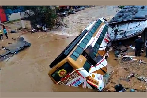 A bus sinks into the road as a canal breaches near the Hyderabad airport